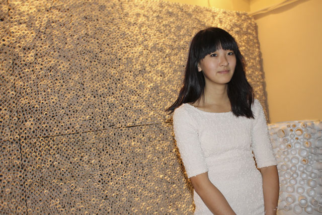 In front of her work