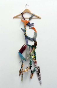 "Fashionably High (Art)" 2012 Found paper images and wooden clothes hanger. approx. 20" by 54"