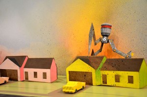 The Neighborhood Is On Fire: She Gone And Done It – 2014            1:72 scale model of alien attack made from wood, paint, sheet metal, lathe-turned parts, & laser cut childhood home            variable dimensions