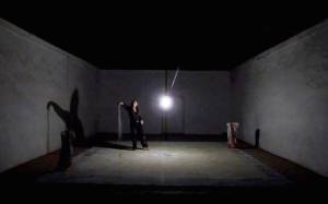 “I Bit The Dust”   Performance. Materials: mineral dust, dye, center hanging lightbulb, stage. 2014 