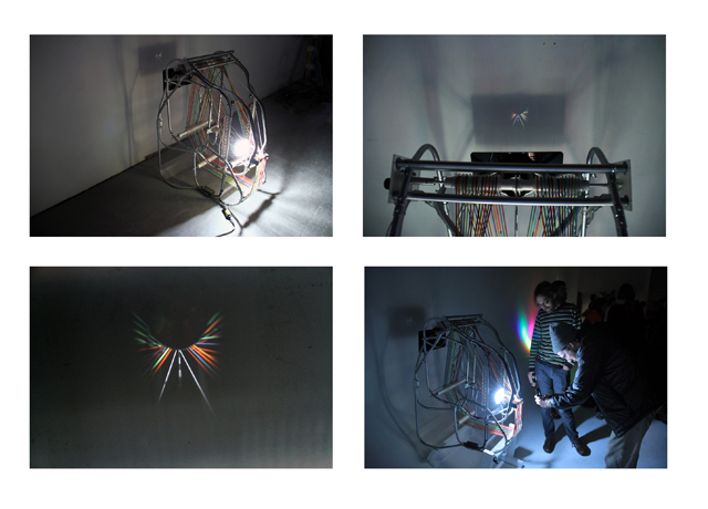 INFINITAS VIA, (composite image), Electrical conduit, colored elastic, lens, motor, hardware. 28"x40"x40".  2012 
