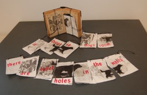 “Croatian Prayer”, Altered Book with Transfer Prints, Ink, Thread, 5”H x about 27”W, 16”D,2013