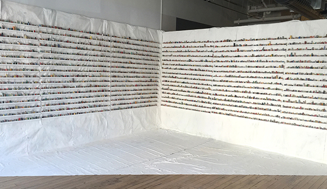 “the sculptural painting: number two” rolled up paintskins on wooden shelves, 8’x15’10’, 2015