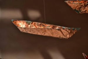 Paper, paint, thread and copper leaf, 1000 origami canoes 12’ x 40’ ( 3.65 x 12.1 metres ) installation 2015